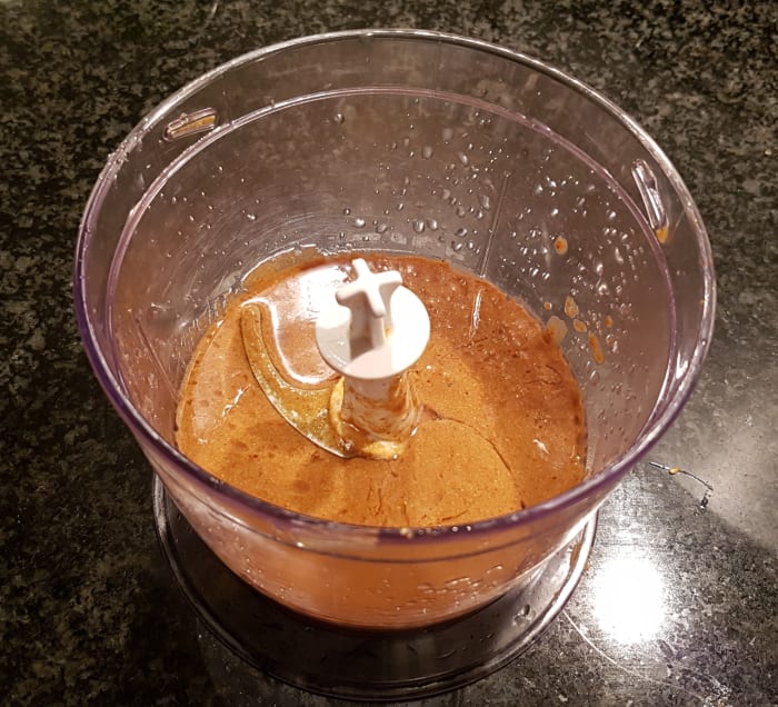 Step 1: Combine the tahini paste, the clove of garlic and the juice of 1 large lemon into your food processor, and process on high speed.