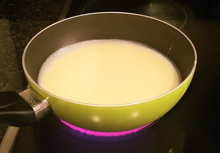 Pour the sweetened condensed milk into a heavy based pan and warm up on a medium heat. This is to help dissolve the cocoa powder. When warm, remove from the heat and stir in the unsalted butter, the cocoa powder (sieved) and the vanilla essence.