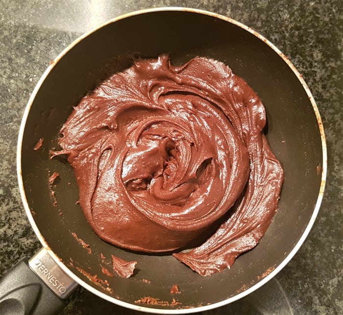 Allow the brigadeiro to cool and stiffen on a cold surface or within the refrigerator for 10 minutes. When ready, the brigadeiro should be easy to hold and malleable like a soft fudge.