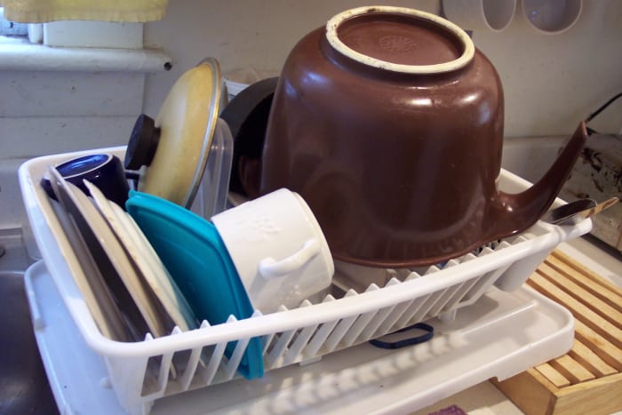 Luxury: Lots of kitchen equipment AND a dishwasher. More likely: No dishwasher; no clean second whatever in the cupboard. Just washing, reusing, and piling everything in the dish drain.