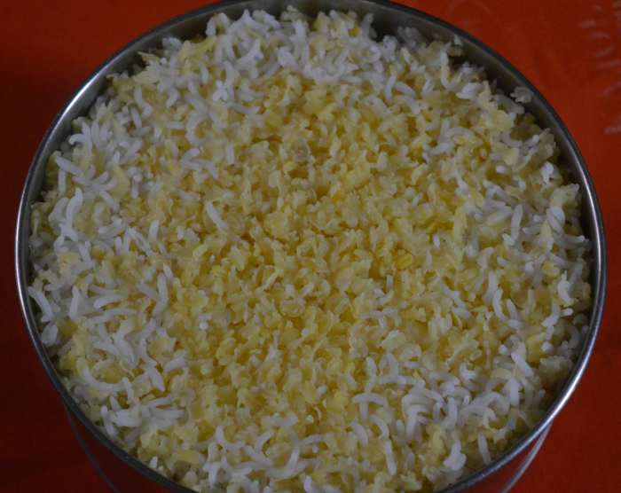 Add fresh water and some salt. Cook until the rice and lentils become soft and a little mushy. Make a mixture of coconut, green chilies, pepper corns, and ginger by grinding.
