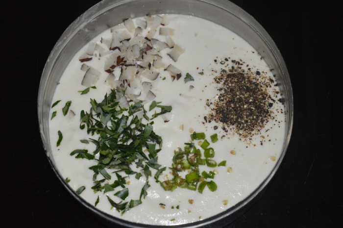 Step two: Grind them adding very little water to get a smooth paste. Add chopped curry leaves, pepper powder, chopped green chilies, chopped dry coconut, and salt.