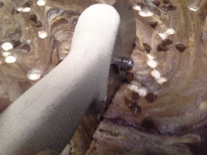 Once the brownie is nice and cooled down, a pizza cutter will run right through it and give you a beautiful cut. It is still up to you if the lines are straight or not.