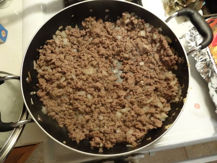 While tomatoes are roasting, cook beef, onion, and garlic in a large skillet over medium high heat until thoroughly cooked (8–10 minutes). Drain, add chili powder, cumin, and coriander then cook an additional 1–2 minutes.
