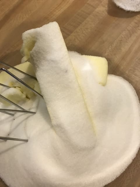 Beat together a cup of regular sugar and a cup of butter until light and fluffy. This forms the basis of the structure for the frosting.