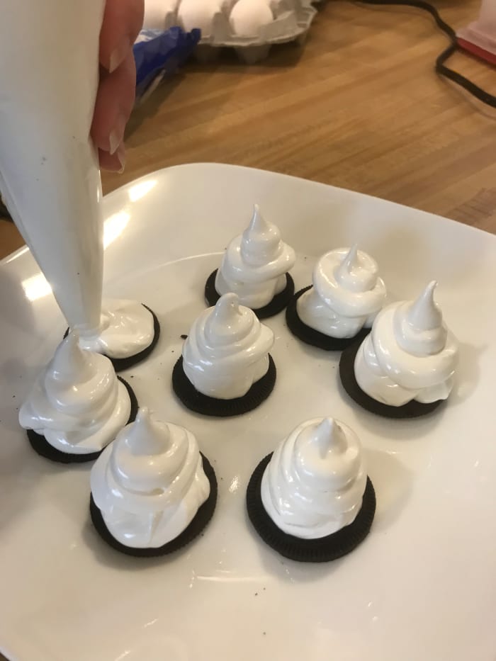 The ghosts are easy to pip with a simple circular motion. Lift the tip of the piping bag straight up to give them "curly" heads.