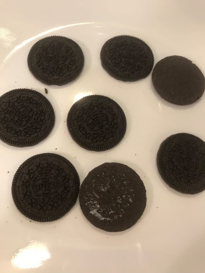 For the base, give your little ghosts half of a chocolate sandwich cookie. Lay them out when you're ready to pipe the ghosts.