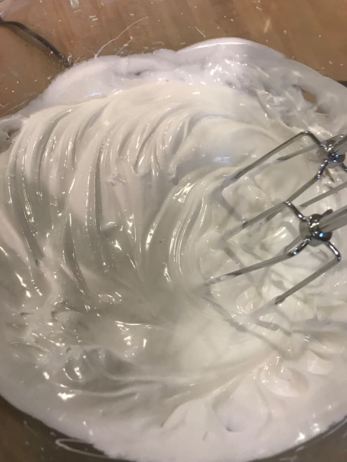 Just keep beating—it takes about 10 full minutes for the correct consistency to form. You're looking for the egg whites to hold stiff peaks, and for the texture to be very glossy.
