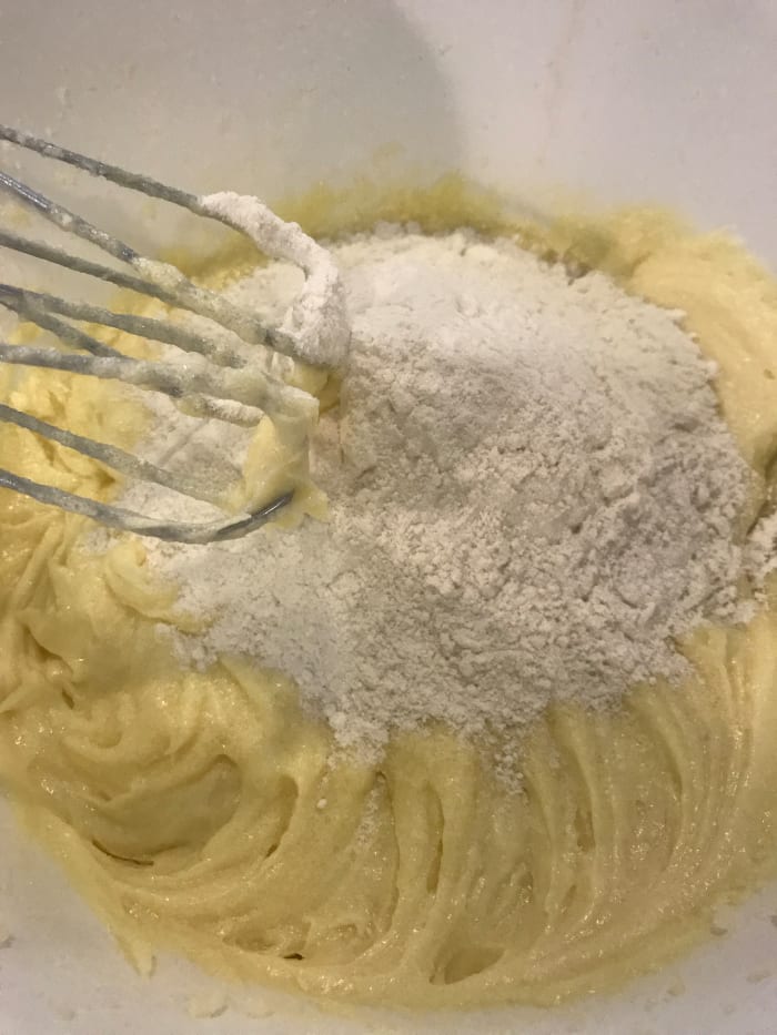 After beating in the eggs, add half the flour mixture and mix well. Working in stages makes it easier to fully incorporate all the ingredients well.