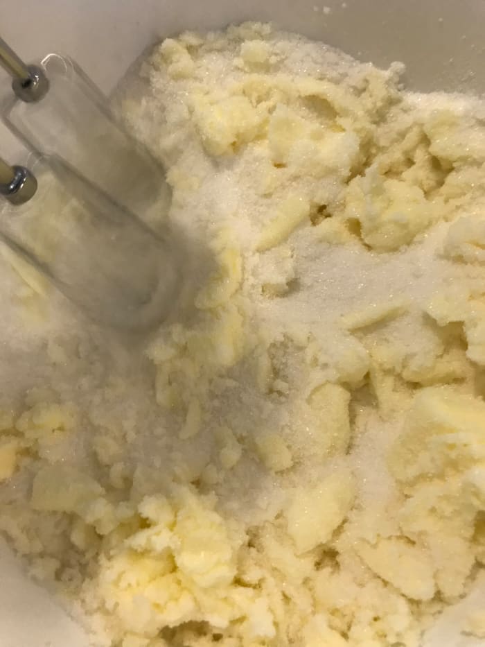 Cream together one cup of butter and 2 1/4 cups of sugar in a large mixing bowl. Beat until light and fluffy, about five minutes, before adding the eggs one at at time.
