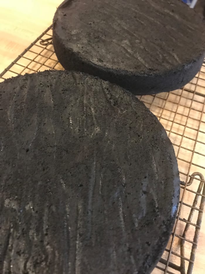 Allow the cakes to cool in their pans for ten minutes before inverting them onto wire racks and removing the parchment papers to cool completely before frosting.
