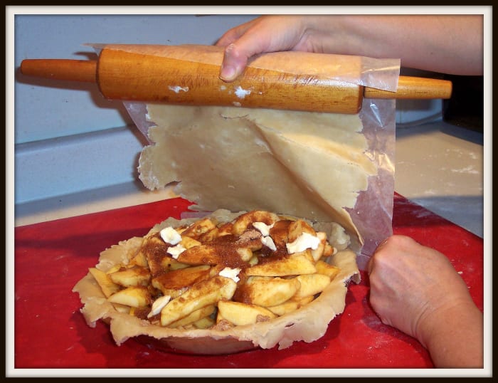 You may gently roll the dough onto the rolling pin, place one edge, crust side down and paper side up, on the edge of the pie plate and then unroll it. Or, gently lift the wax paper off the counter and place it on the pie plate.