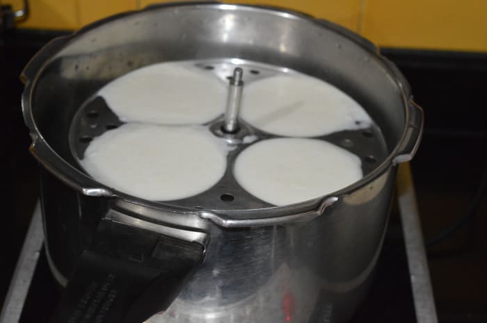 Step eight: Place the idli stand inside the steamer. Close the lid. If you are using a pressure cooker, don't place the weight.