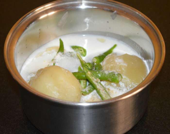 Step one: Cook potatoes till they are soft. Mash them. Add slit green chilies, curds, hing powder, and salt to it. Add some water to adjust the consistency. Mix well.