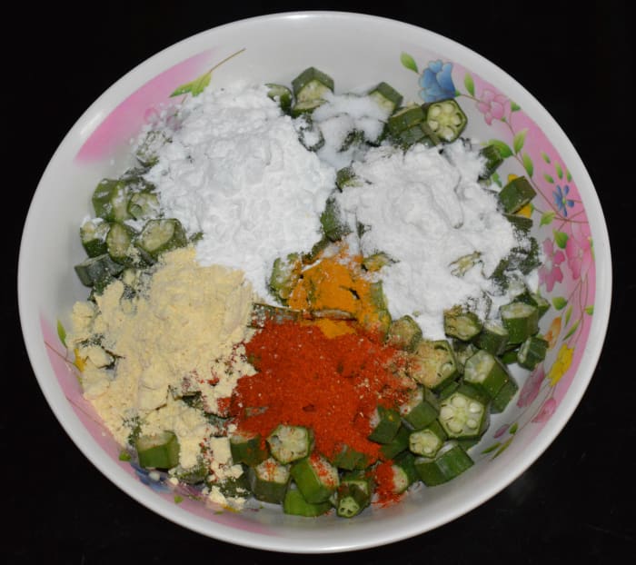 Step 2: Add corn flour, gram flour, rice flour, turmeric powder, red chili powder, chopped green chilies (optional), coriander powder, and salt.