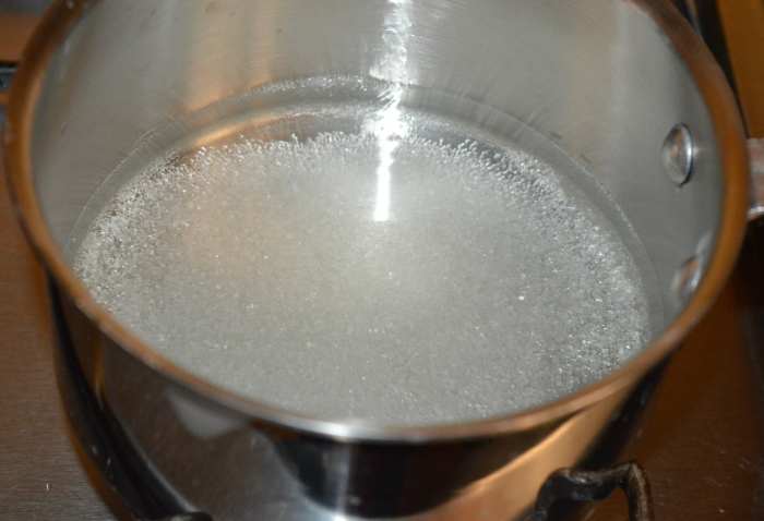 Step one: To make the sugar syrup, add water to a saucepan as per instructions. Add sugar to it. Boil the mixture until it thickens a bit. Throw in cardamom powder. Turn off the heat. Cover it partially.