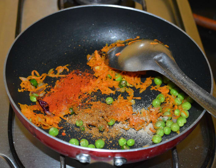 Step two: Throw in red chili powder, garam masala powder, sugar, and chat masala powder. Saute for a few seconds.