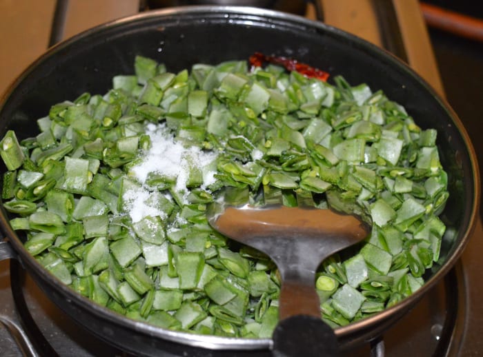 Step three: Add chopped veggies and some salt. Mix well. Increase the heat. Stir-cook them for 3-4 minutes. Next, reduce the heat a little.