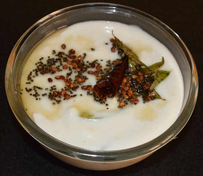 Step four: Add tempering with coconut oil, as per instructions. Mix well. Serve this appetizing chutney with hot steamed rice. Enjoy the taste!
