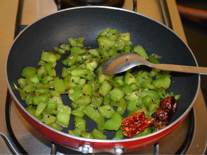 Continue sauteing over medium-high heat till capsicum gets cooked and becomes soft. You can add a few drops of water to keep it moist. Turn off the heat. Keep aside the mixture for cooling.