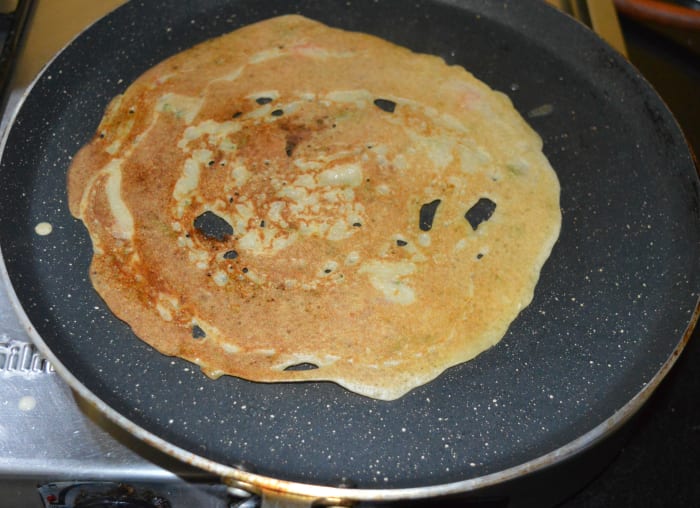 Keep the heat on medium-high. Flip it once the bottom becomes golden brown. Add a few drops of oil on the other side, also.
