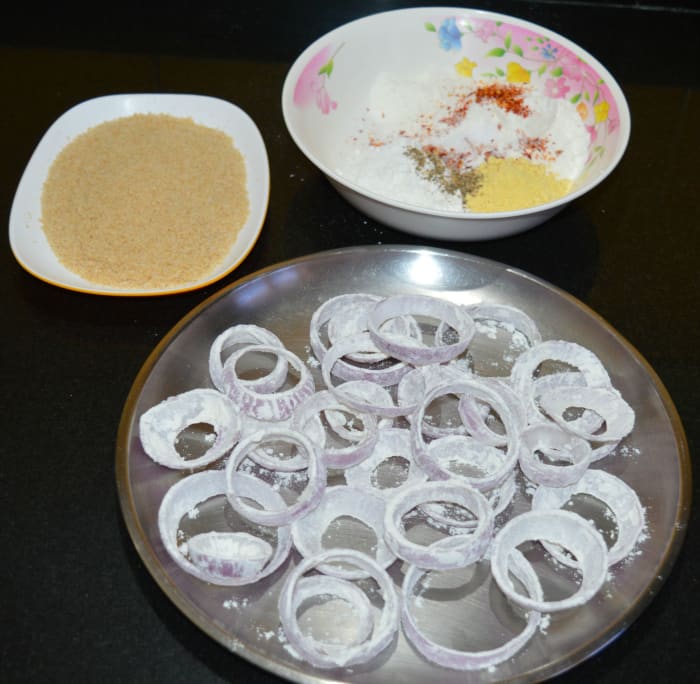Step three: Make fresh bread crumbs. For that, grind bread pieces in a mixer. Collect them on a plate.
