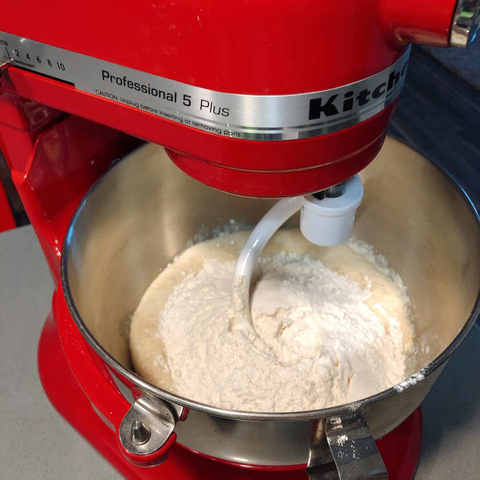 In a mixing bowl, combine the yeast mixture, flour, salt, sugar, and egg mixture. Use a stand mixer, beat the ingredients at the medium speed for 5 minutes.