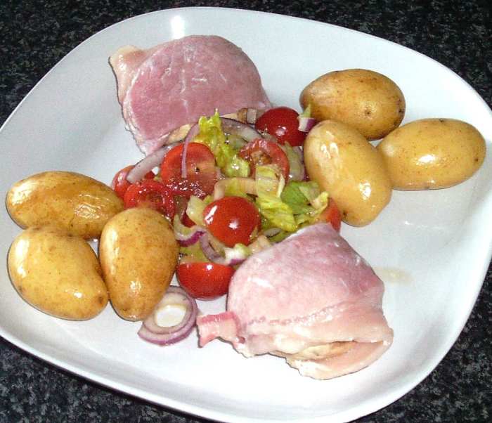Garlic mushroom and mozzarella bacon wrapped mushrooms are served with boiled potatoes and dressed simple salad