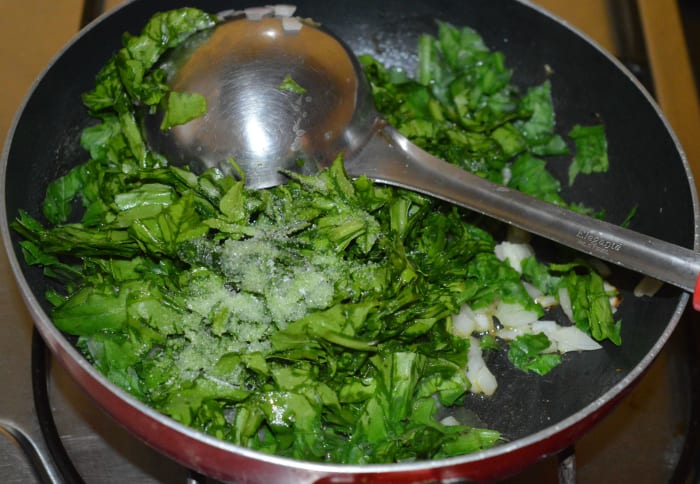 Step two: Add chopped spinach. Throw in salt and sugar. Saute the mix for about 5 minutes on a medium-high flame.