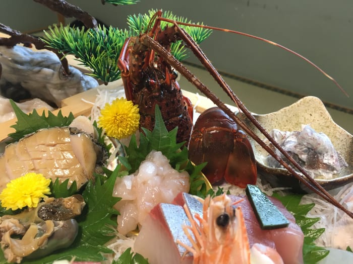 Ise ebi looks like lobster (this is a sashimi plate that included raw ise ebi, right in front of the decorative shell)