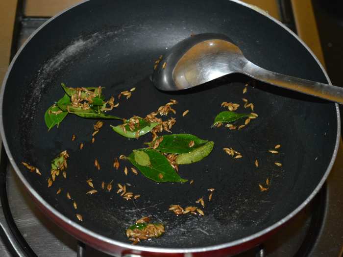 Step 2: Heat butter/ghee/olive oil in a deep-bottomed pan. Throw in the cumin seeds. Let them splutter. Add the curry leaves. Saute for a few seconds.