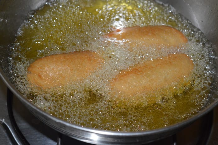 Step five: Deep-fry 3-4 of them in oil until they become light brown. Remove, and place them on an absorbent paper towel.