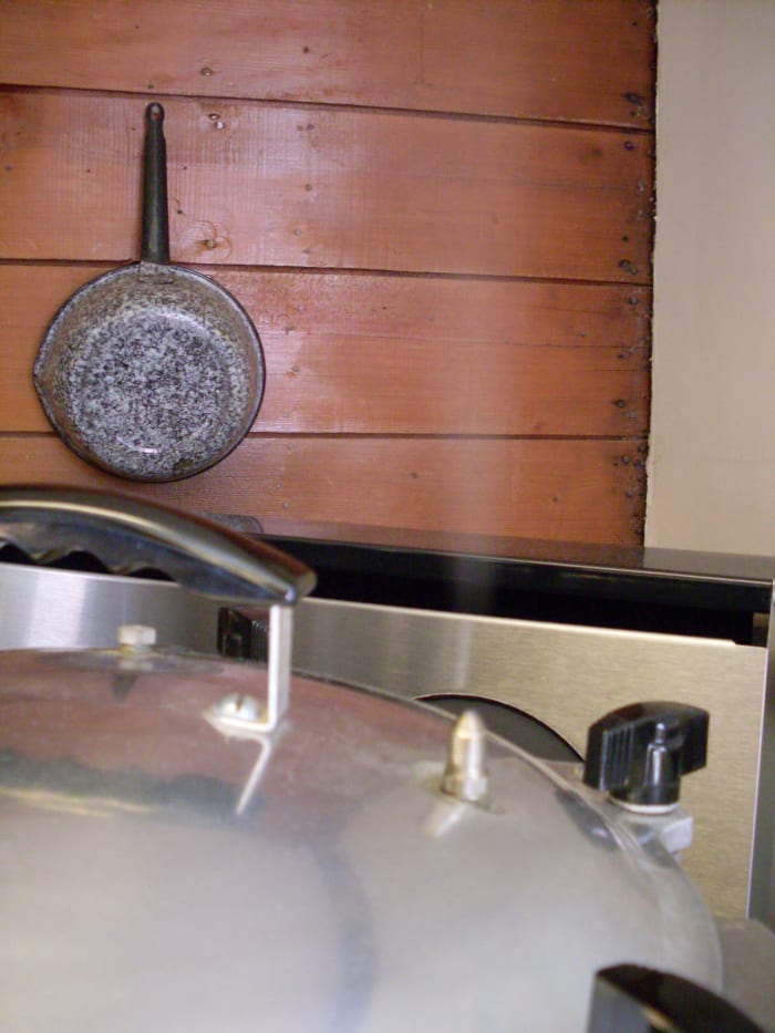 Now the steam is coming through the pressure spout. Wait 10 minutes (older sources may say seven) to put the weight on, at 10 lbs. pressure. Venting the pressure canner for 10 minutes ensures that the air is forced out of the canner.