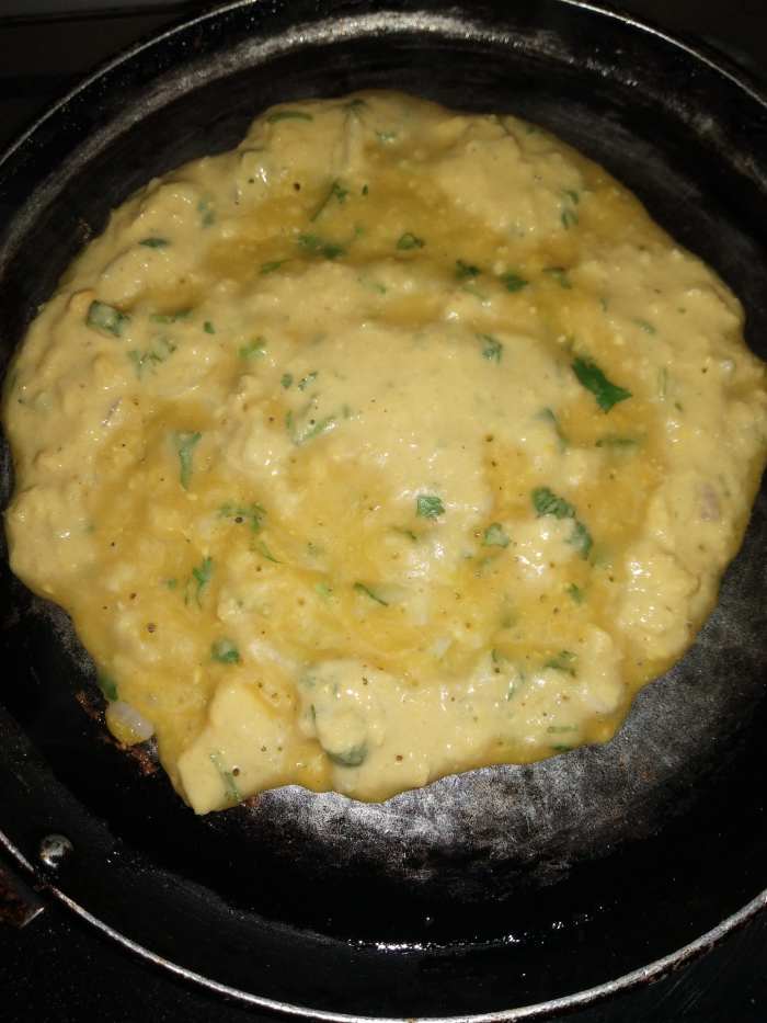 Heat tawa, and grease with oil. Pour ladle full of batter in the center and rotate the batter with the help of a ladle in a circular motion to make a round dosa.