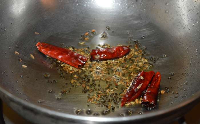 Step one: Heat oil in a deep-bottomed pan. Throw in the mustard seeds. Let them crackle. Add cumin seeds and broken dry red chilies. Saute for a few seconds.