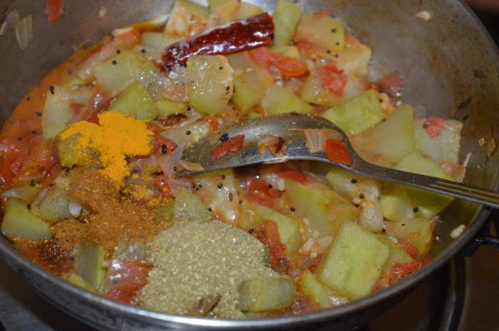 Step six: Add turmeric powder, garam masala powder, and cumin-coriander powder. Saute for 1 minute. Add tamarind paste or dry mango powder