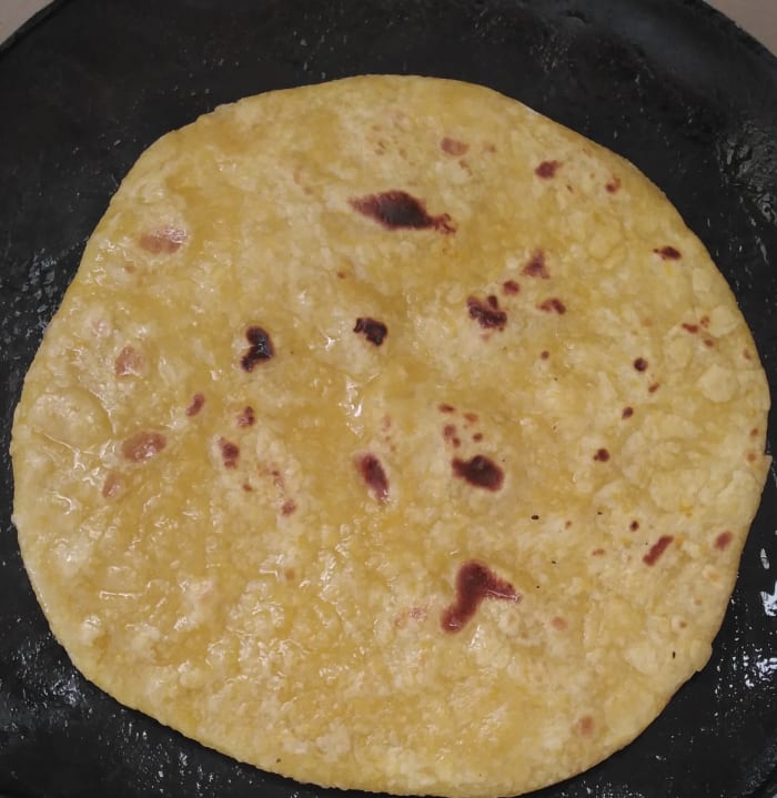 Apply 1 tablespoon of oil on the cooked side. After 1 minute, flip it and apply oil on the other side.