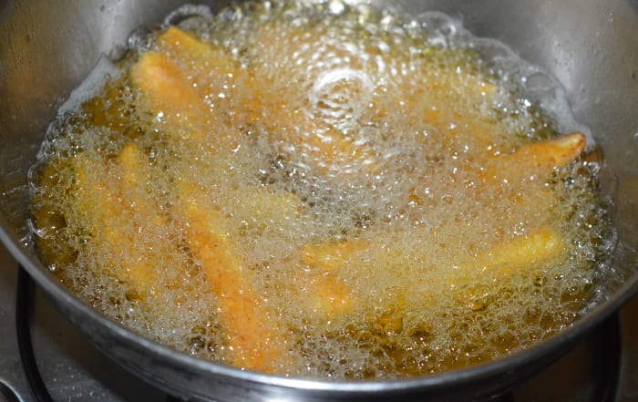 Step four: Deep-fry them in the moderately hot oil. Turn them occasionally to ensure uniform frying. Fry them until they become crispy and golden.