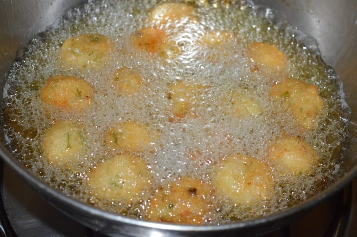 Step two: Heat the oil for deep-frying. Pick up lemon-sized portions of the batter and gently slide them into the hot oil.