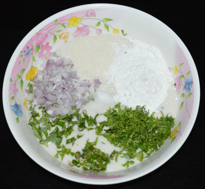 Step one: Add all the ingredients except oil to a mixing bowl. Mix well to make a thick batter. Adjust the consistency by adding more rice flour. Set aside the batter for 10 minutes.