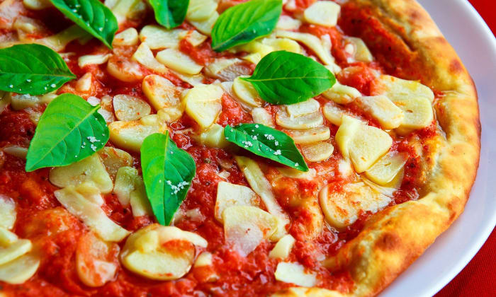 Margherita pizza was designed in the late 1800s by Raffaele Esposito. It was designed to resemble the colors of the Italian flag, and was served to Queen Margherita of Savoy, who it was named after.