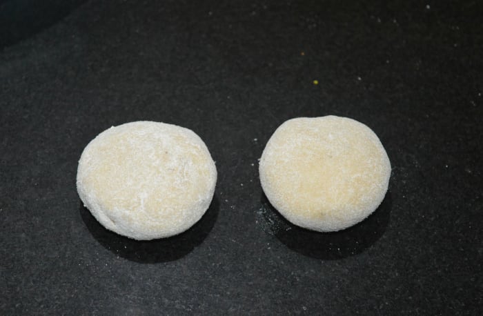 Step five: Pinch out a small portion (lemon-sized) of dough. Make a patty out of it. Dip it in wheat flour. Roll into a 3-inch disc.