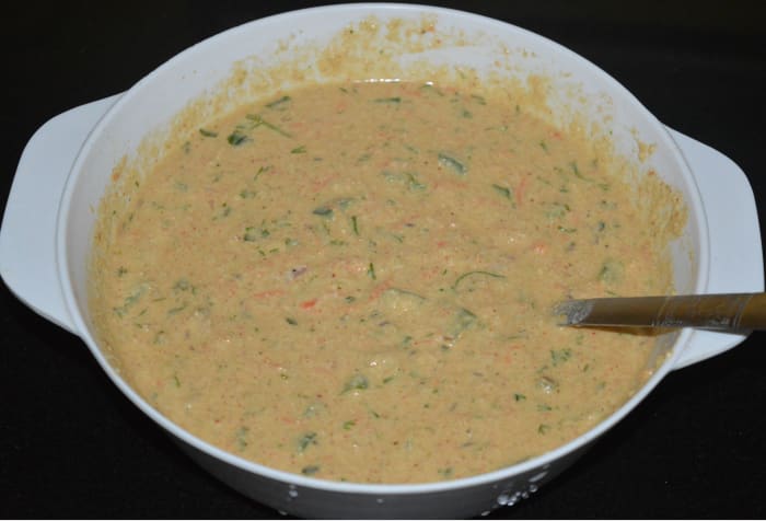 Step two: Mix well. Prepare a thick batter adding water little by little. Cover it and set aside for 6-7 minutes.