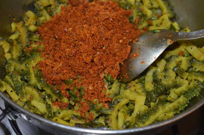 Step 4: Add the ground masala powder. Mix well and cover the pan for a minute. Ensure that the jaggery powder melts and combines well with the other ingredients.