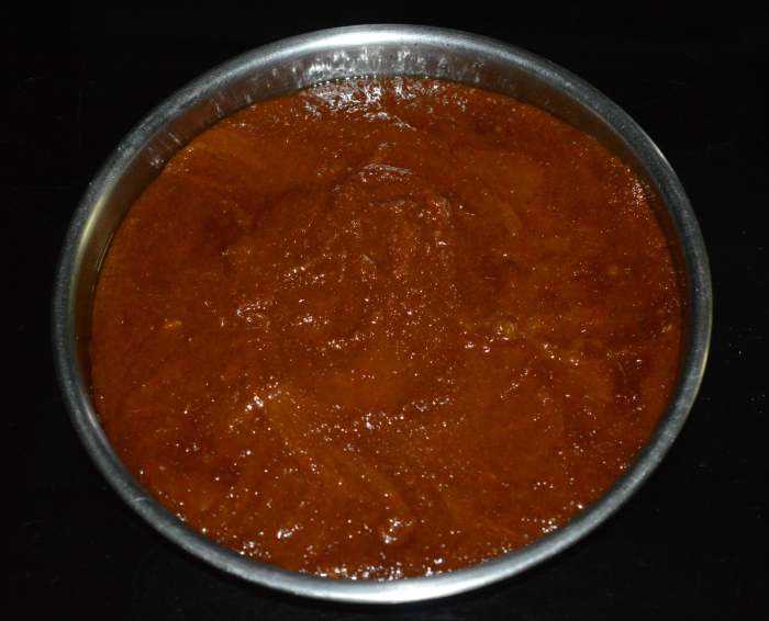 Step five: At this point, turn off the heat and pour the mixture onto a greased plate. Spread it with a spatula.