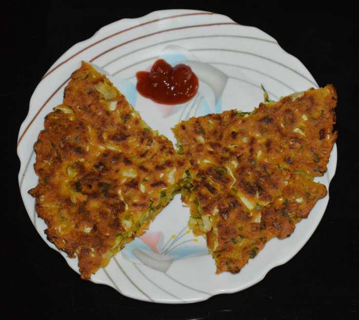 Now, you will get the cabbage pancake on the plate. Cut it in your desired shape. Serve hot with tomato sauce. Enjoy!