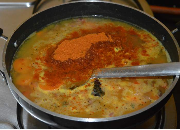 Add turmeric powder, tamarind paste, jaggery powder, remaining salt, and sambar powder. Add 3-4 cups of water.