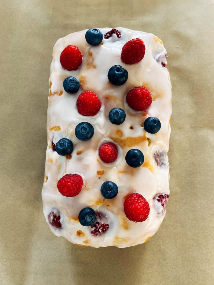 I decided to decorate the bread with more fresh raspberries and blueberries on top of the lemon glaze.