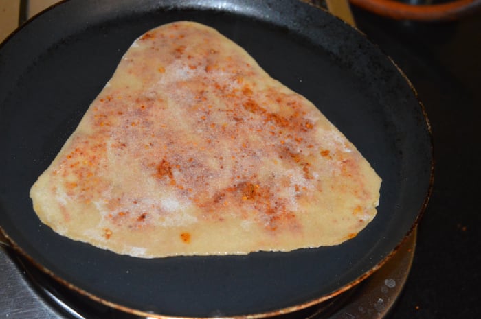 Step five: Cook it on a pan while adding a few drops of oil on both the sides. Let both sides become golden brown. Your favorite spicy paratha is ready!
