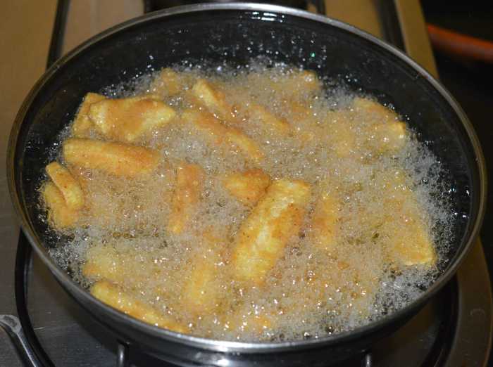 Deep-fry the batter-coated baby corn in small batches in moderately hot oil. Fry until they become crispy and golden brown.